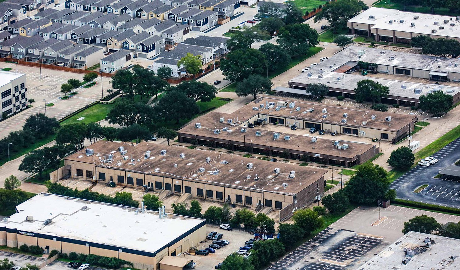 Aerial — Techniplex Business Center flex-industrial park, multiple warehouse/flex buildings with truck courts and parking, 16203 Park Row