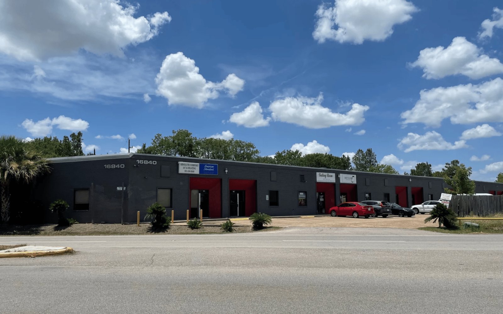 Flex-industrial building exterior — dark brick facade, red service doors, 16840 Clay Rd